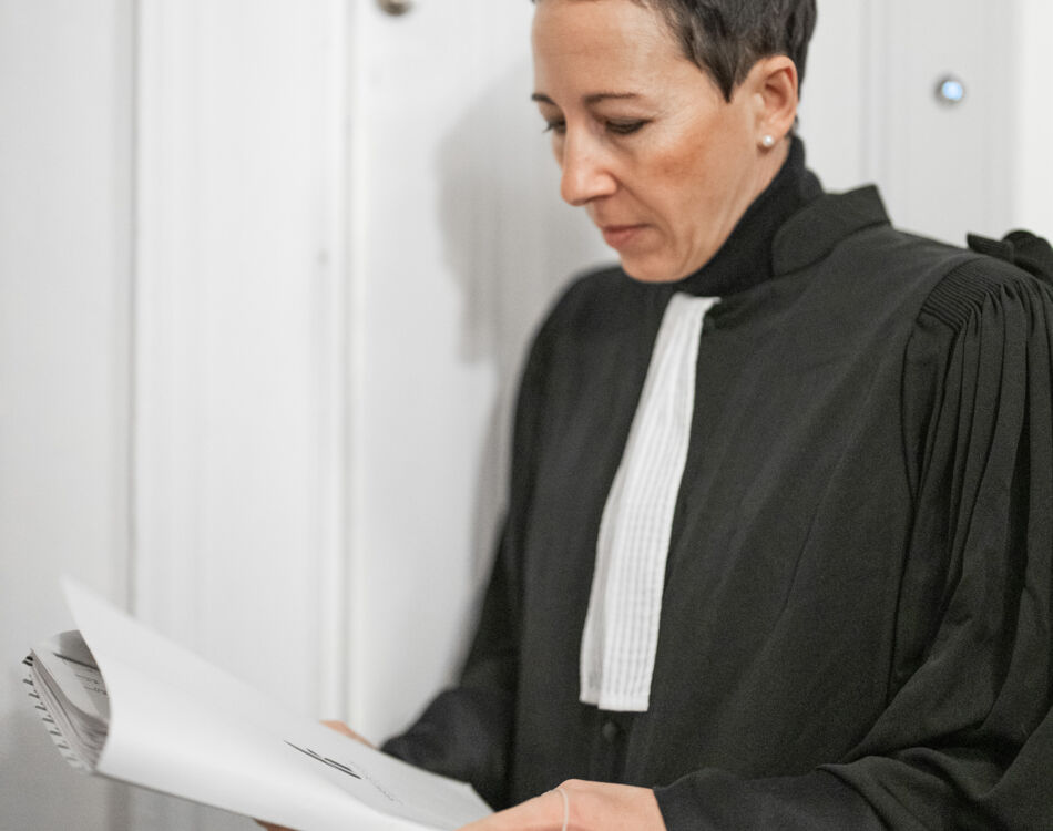 Karine DeLuca en tenue d'avocat lisant un dossier. karine-de-luca-mk-godin-05833